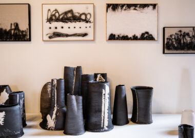 Cluster of black clay vessels as part of Dan Kelly's work in the 2023 British Ceramics Biennial