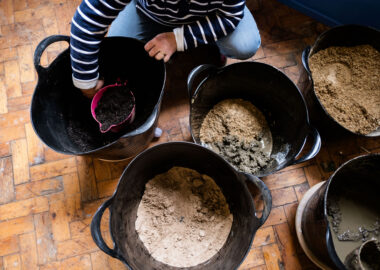 Overhead view of buckets filled with clay, sawdust, compost and sand.